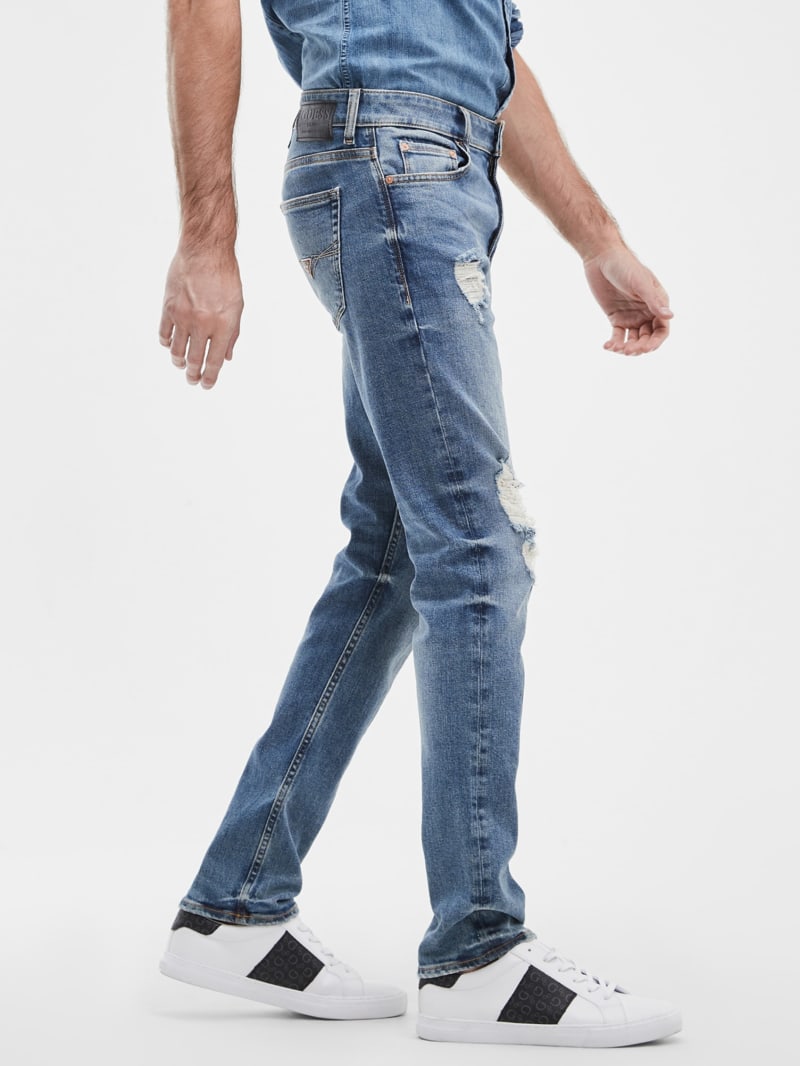 GUESS Slim Tapered Jeans In Dusty Indigo Destroy Wash, $128, GUESS