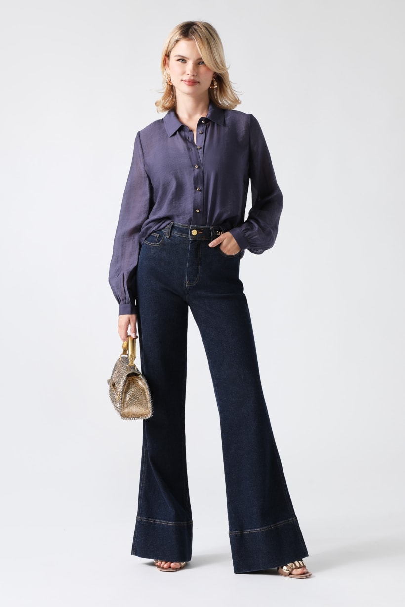 Woman in dark flare jeans with blouse